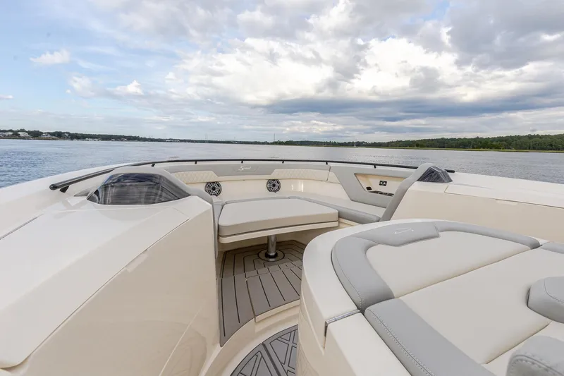 Your Next Boat! Yacht Photos Pics 2024 Scout 377 LXF boat interior with luxurious seating on a calm water backdrop.