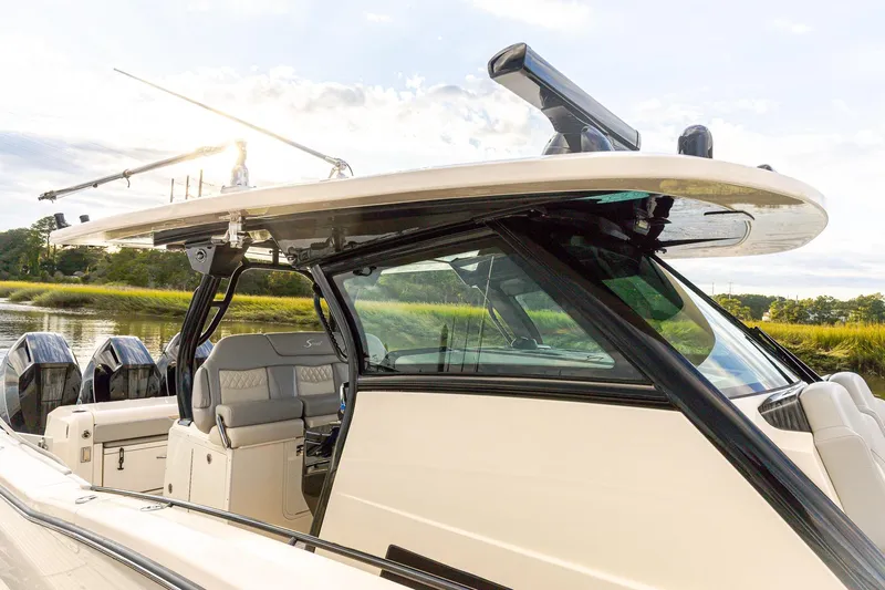 Your Next Boat! Yacht Photos Pics 2024 Scout 377 LXF boat with sleek design and modern features, docked by the water.