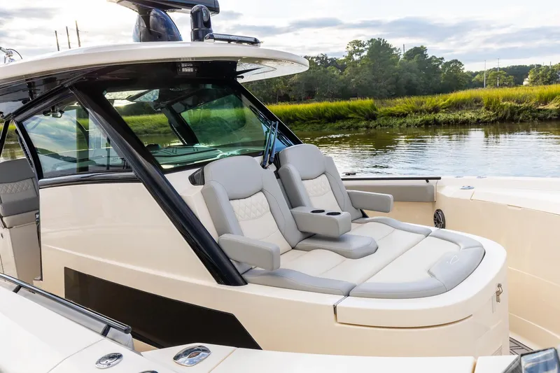 Your Next Boat! Yacht Photos Pics 2024 Scout 377 LXF boat interior with luxurious seating by the water.