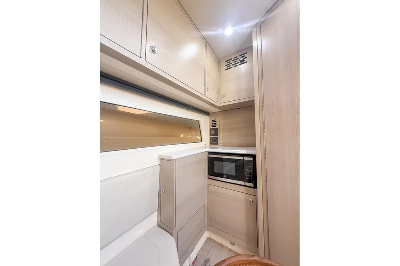 Your Next Boat! Yacht Photos Pics 2024 Scout 377 LXF interior with modern cabinetry and built-in microwave.