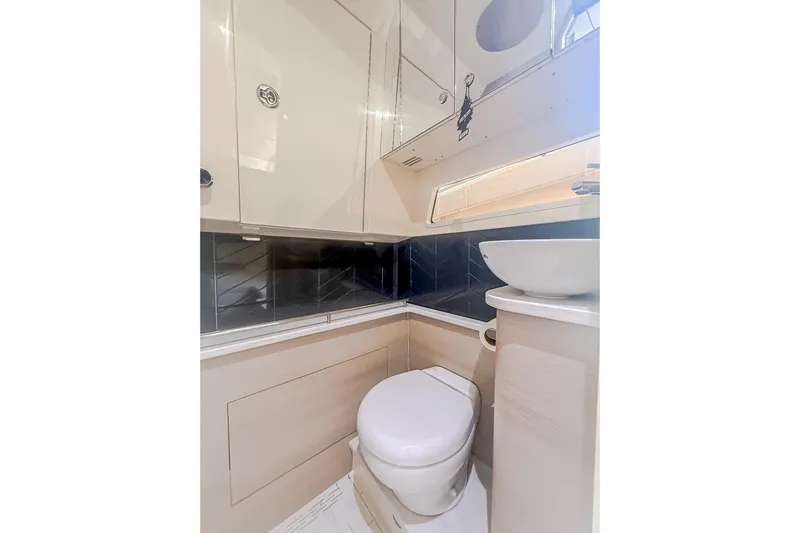 Your Next Boat! Yacht Photos Pics 2024 Scout 377 LXF boat bathroom with modern fixtures and sleek design.