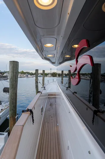 New 2024 Sirena 58 Yacht Photos Pics 2024 Sirena 58 Flybridge yacht docked, showcasing sleek design and modern lighting.