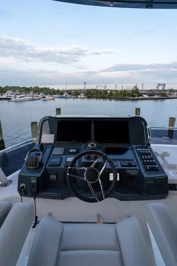 New 2024 Sirena 58 Yacht Photos Pics 2024 Sirena 58 Flybridge yacht helm with modern controls, overlooking marina.