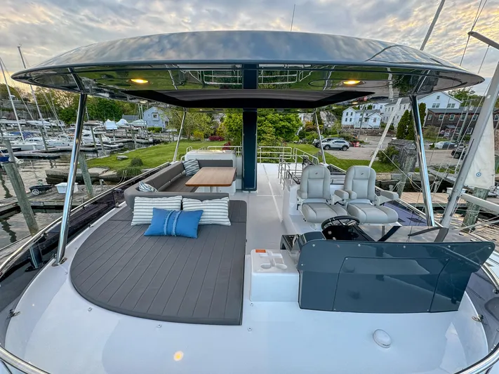 New 2024 Sirena 58 Yacht Photos Pics 2024 Sirena 58 Flybridge yacht with spacious deck, seating, and helm station.