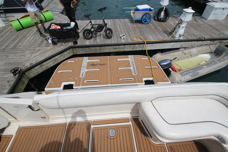  Yacht Photos Pics 1998 Sea Ray 500 Sundancer docked, showing swim platform and marina equipment.