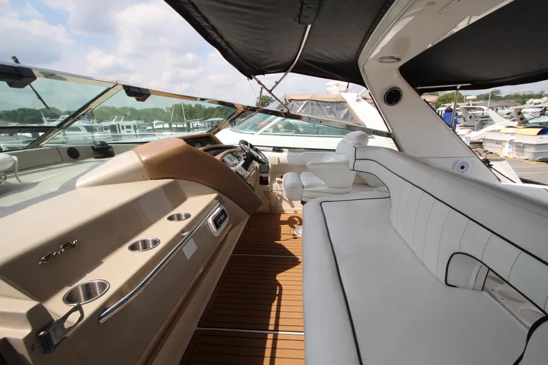  Yacht Photos Pics 1998 Sea Ray 500 Sundancer yacht interior with white seating and wooden flooring.