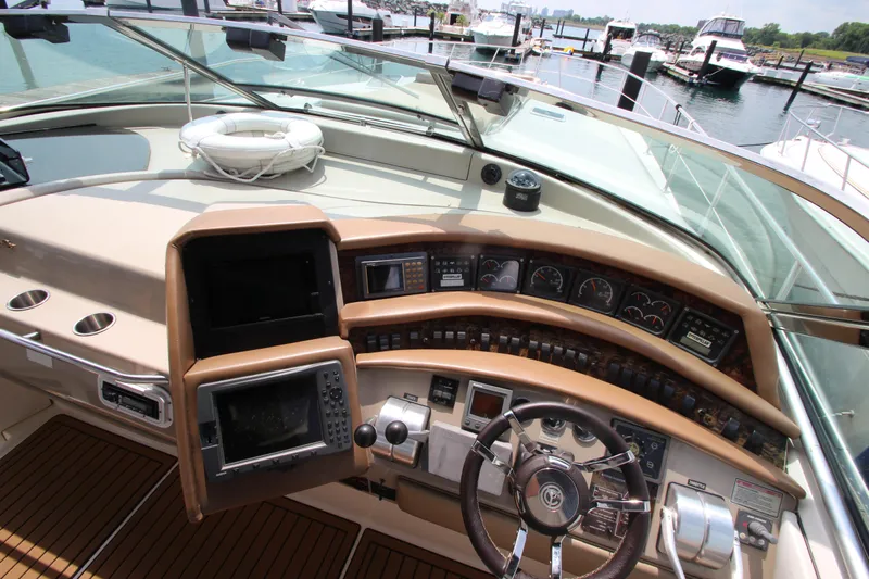  Yacht Photos Pics 1998 Sea Ray 500 Sundancer helm with navigation instruments and steering wheel.