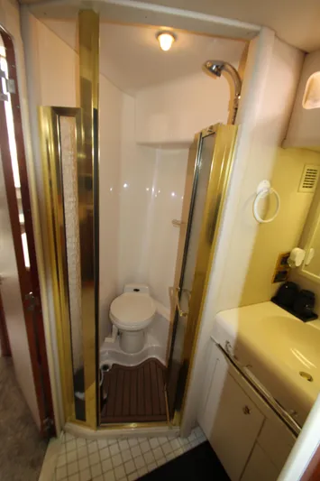  Yacht Photos Pics 1998 Sea Ray 500 Sundancer bathroom with shower, toilet, and sink.