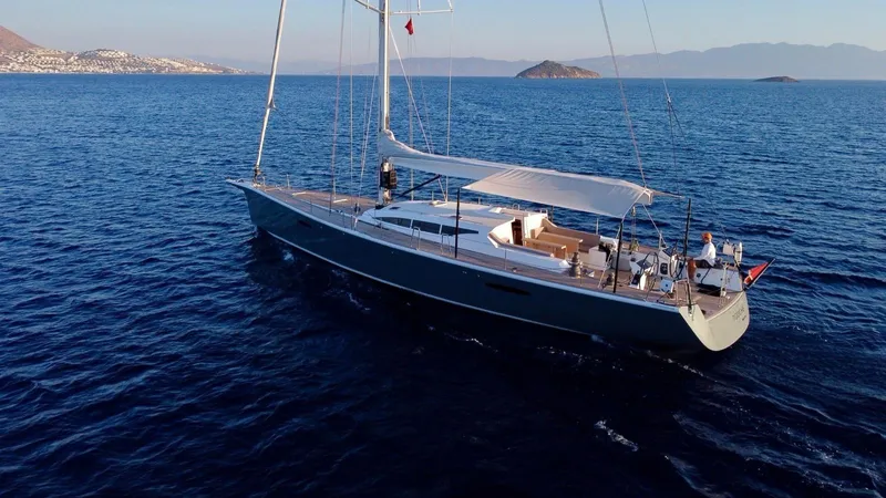 Touché Yacht Photos Pics Sailing yacht Windseeker Raised Pilot Saloon 2010 on open sea with scenic island backdrop.