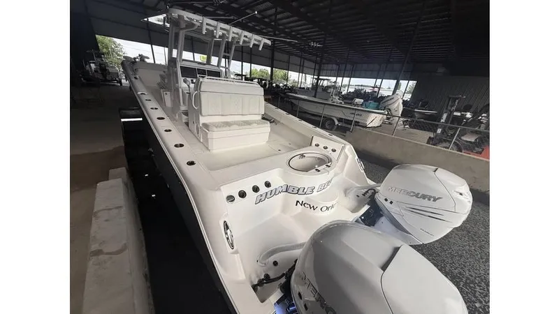  Yacht Photos Pics 2022 Invincible 33 Catamaran with dual Mercury engines in a covered marina.