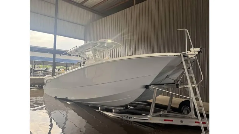  Yacht Photos Pics 2022 Invincible 33 Catamaran on trailer in covered storage area.