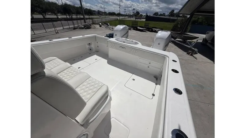  Yacht Photos Pics 2022 Invincible 33 Catamaran with white seating and dual outboard motors.