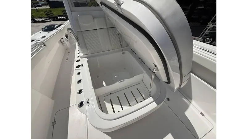  Yacht Photos Pics Open storage compartment on 2022 Invincible 33 Catamaran boat, showcasing spacious interior design.