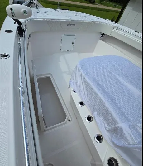  Yacht Photos Pics 2022 Invincible 33 Catamaran interior with white seating and storage compartments.