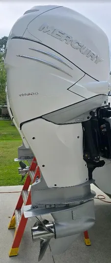  Yacht Photos Pics 2022 Invincible 33 Catamaran with Mercury outboard engine, displayed outdoors.