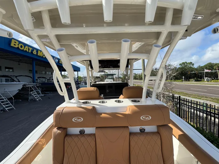  Yacht Photos Pics 2025 Key West 291 FS boat interior with tan seating and rod holders, at a dealership.