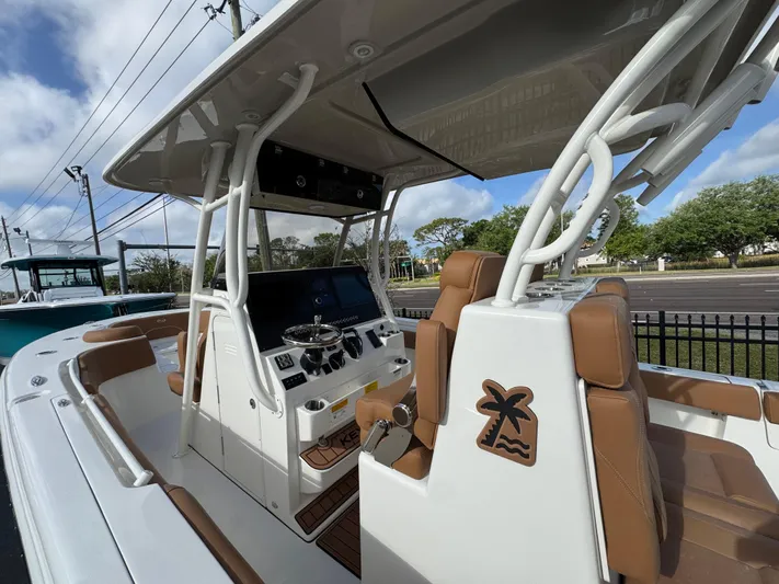  Yacht Photos Pics 2025 Key West 291 FS boat interior with brown seating and modern dashboard.