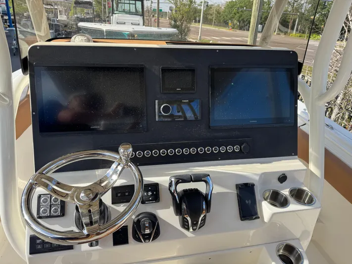  Yacht Photos Pics 2025 Key West 291 FS boat dashboard with steering wheel and dual screens.