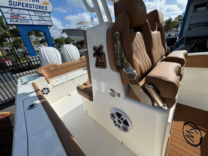  Yacht Photos Pics 2025 Key West 291 FS boat interior with tan seating and speaker system.
