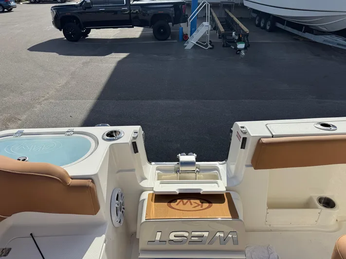  Yacht Photos Pics 2025 Key West 291 FS boat interior with seating and storage, parked near a black truck.