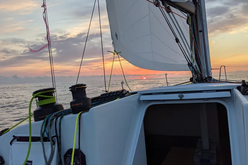 Expresso Yacht Photos Pics Sailing on a 2019 Pogo 36 yacht at sunset, vibrant sky and calm sea.