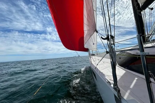 Expresso Yacht Photos Pics Sailing on a 2019 Pogo 36 yacht with vibrant red sail against blue sky.