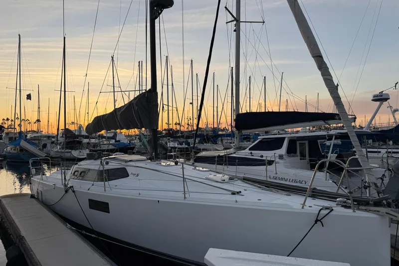 Expresso Yacht Photos Pics Sailboats docked at sunset, featuring a 2019 Pogo 36 model.
