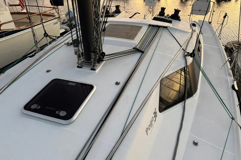 Expresso Yacht Photos Pics 2019 Pogo 36 sailboat deck with rigging and hatch, docked at sunset.