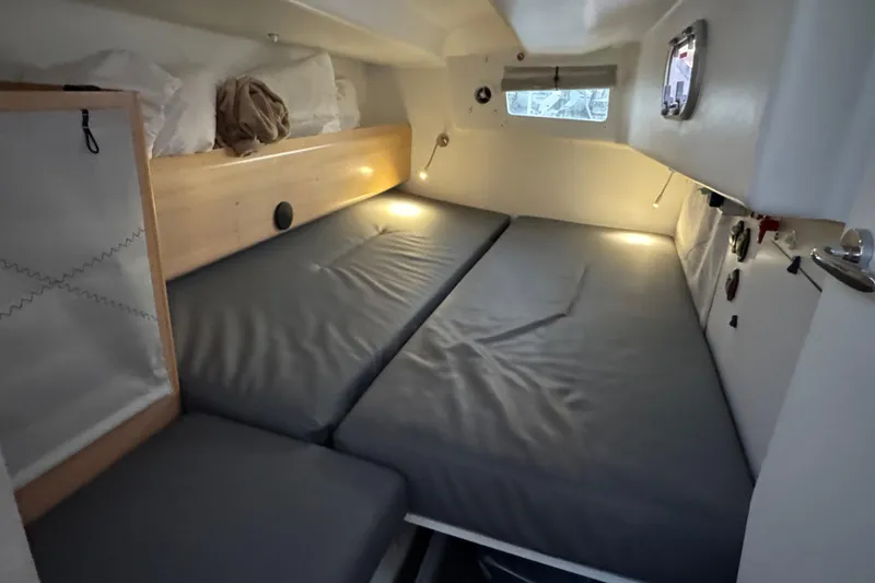 Expresso Yacht Photos Pics Cozy cabin interior of 2019 Pogo 36 sailboat with comfortable bedding and ambient lighting.