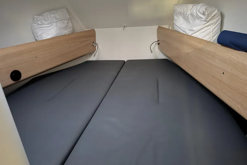 Expresso Yacht Photos Pics Cozy cabin interior of 2019 Pogo 36 sailboat with cushioned sleeping area.