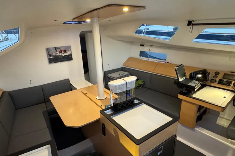 Expresso Yacht Photos Pics Modern interior of 2019 Pogo 36 sailboat with seating, table, and navigation equipment.