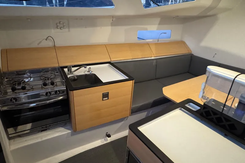 Expresso Yacht Photos Pics 2019 Pogo 36 yacht interior with kitchen, stove, sink, and seating area.