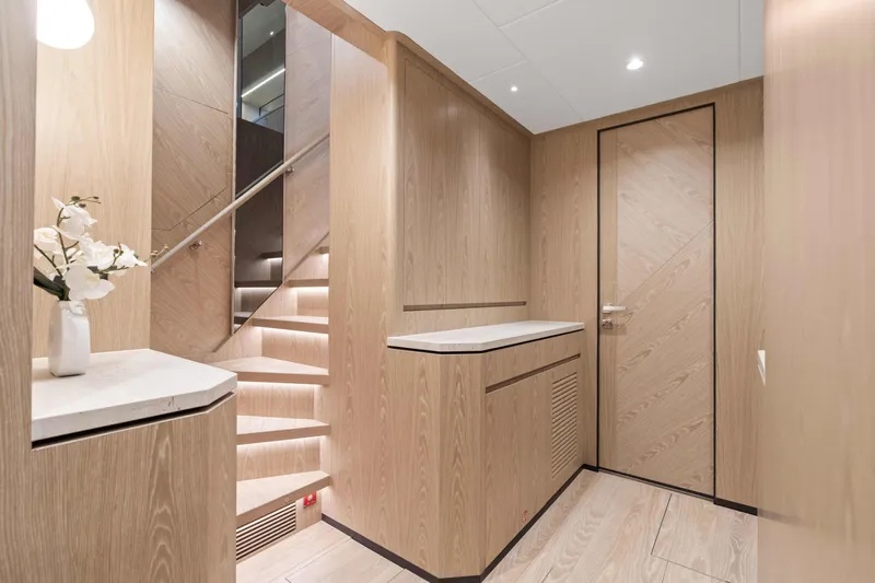 Horizon Fd100-914 / Available Flibs 2025 Yacht Photos Pics Luxurious interior of 2026 Horizon FD100 yacht with elegant wood paneling and modern staircase.