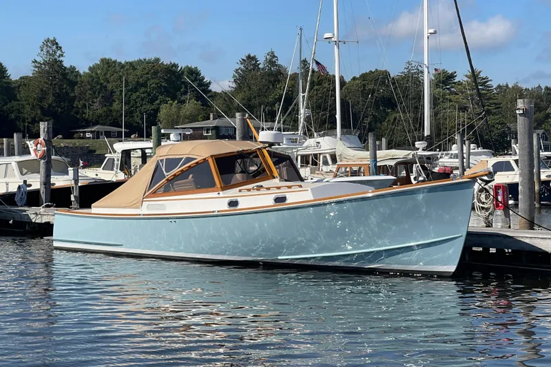 Sea Glass Yacht Photos Pics 2015 CH Marine Shelter Island Runabout docked at a marina, surrounded by other boats.