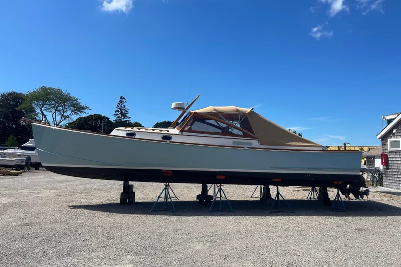 Sea Glass Yacht Photos Pics 2015 CH Marine Shelter Island Runabout on stands, under clear blue sky.