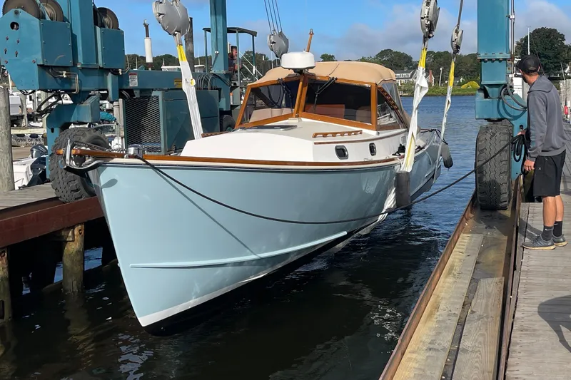 Sea Glass Yacht Photos Pics 2015 CH Marine Shelter Island Runabout being lifted at a marina dock.
