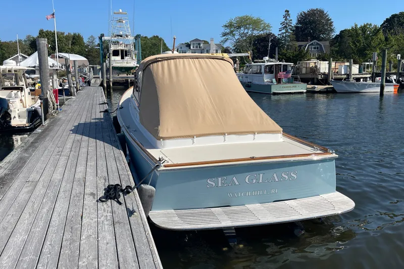 Sea Glass Yacht Photos Pics 2015 CH Marine Shelter Island Runabout docked, featuring "Sea Glass" name and tan cover.