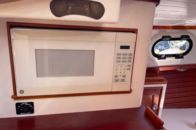 Sea Glass Yacht Photos Pics Microwave in 2015 CH Marine Shelter Island Runabout interior with wood accents and porthole.