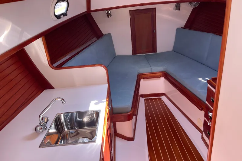 Sea Glass Yacht Photos Pics 2015 CH Marine Shelter Island Runabout interior with cozy seating and compact sink area.