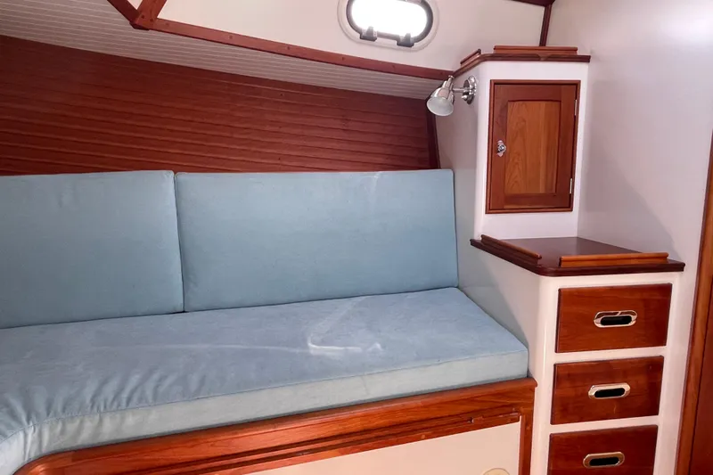 Sea Glass Yacht Photos Pics 2015 CH Marine Shelter Island Runabout interior with blue cushions and wooden cabinetry.