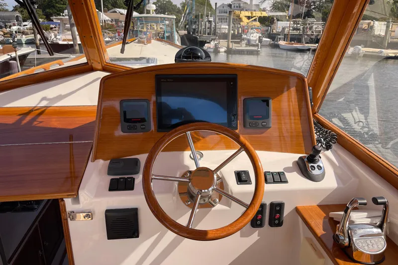 Sea Glass Yacht Photos Pics 2015 CH Marine Shelter Island Runabout dashboard with wooden steering wheel and navigation controls.
