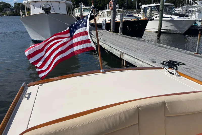 Sea Glass Yacht Photos Pics 2015 CH Marine Shelter Island Runabout with American flag at marina dock.