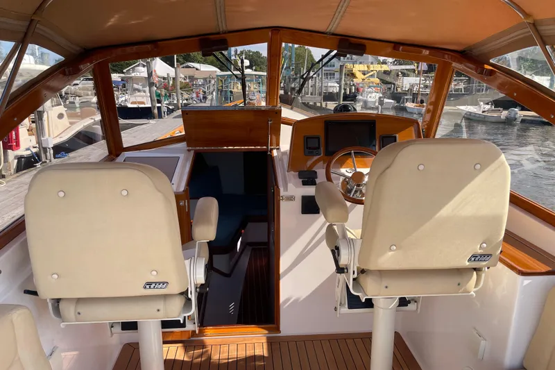 Sea Glass Yacht Photos Pics 2015 CH Marine Shelter Island Runabout interior with helm, seats, and marina view.