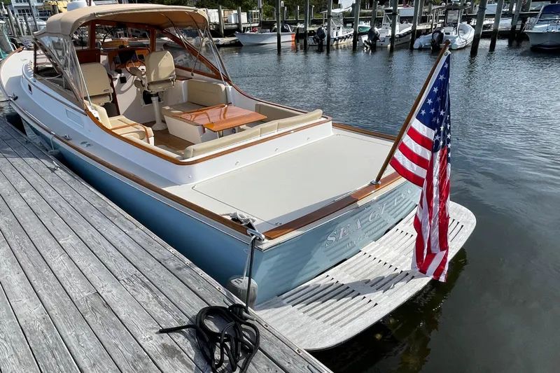 Sea Glass Yacht Photos Pics 2015 CH Marine Shelter Island Runabout docked, featuring American flag and elegant interior.