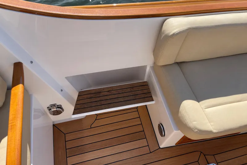 Sea Glass Yacht Photos Pics 2015 CH Marine Shelter Island Runabout interior with teak flooring and beige seating.