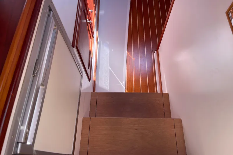 Sea Glass Yacht Photos Pics Staircase inside 2015 CH Marine Shelter Island Runabout, featuring wooden steps and paneling.