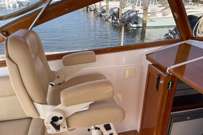 Sea Glass Yacht Photos Pics Luxurious interior of 2015 CH Marine Shelter Island Runabout with beige seating and wooden accents.