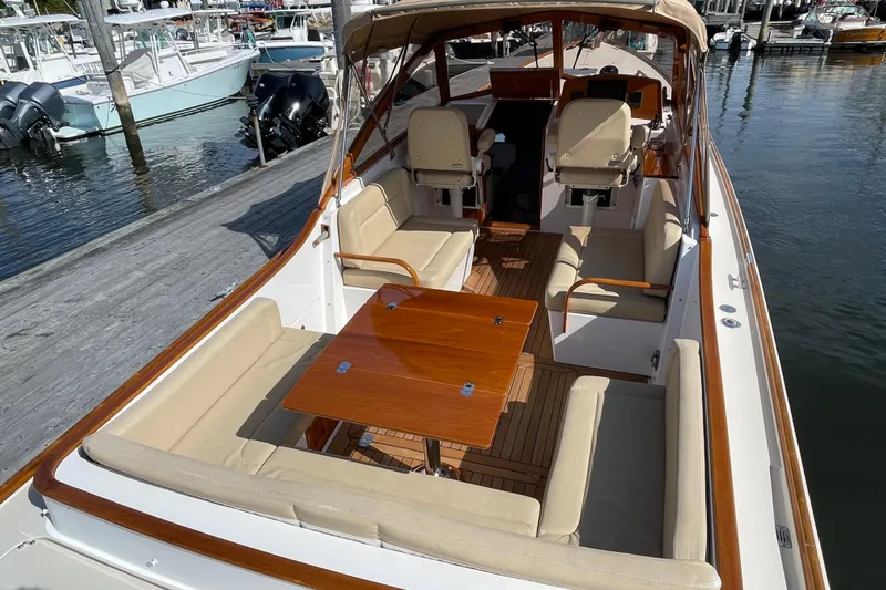 Sea Glass Yacht Photos Pics 2015 CH Marine Shelter Island Runabout with elegant seating and wooden table at dock.