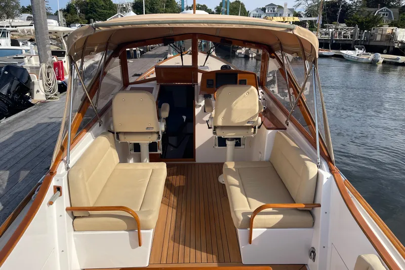 Sea Glass Yacht Photos Pics 2015 CH Marine Shelter Island Runabout with beige seating and wooden deck at a marina.