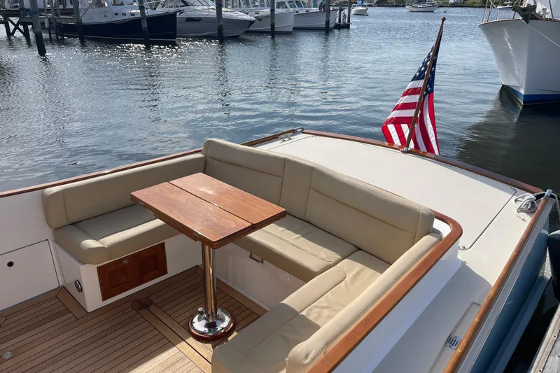 Sea Glass Yacht Photos Pics 2015 CH Marine Shelter Island Runabout with seating area and American flag on calm water.